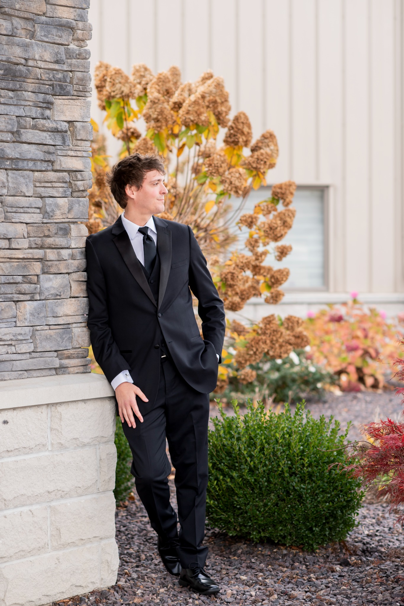 Cropped anonymous portrait of Kaito Michi in formal attire, with the face intentionally outside the frame